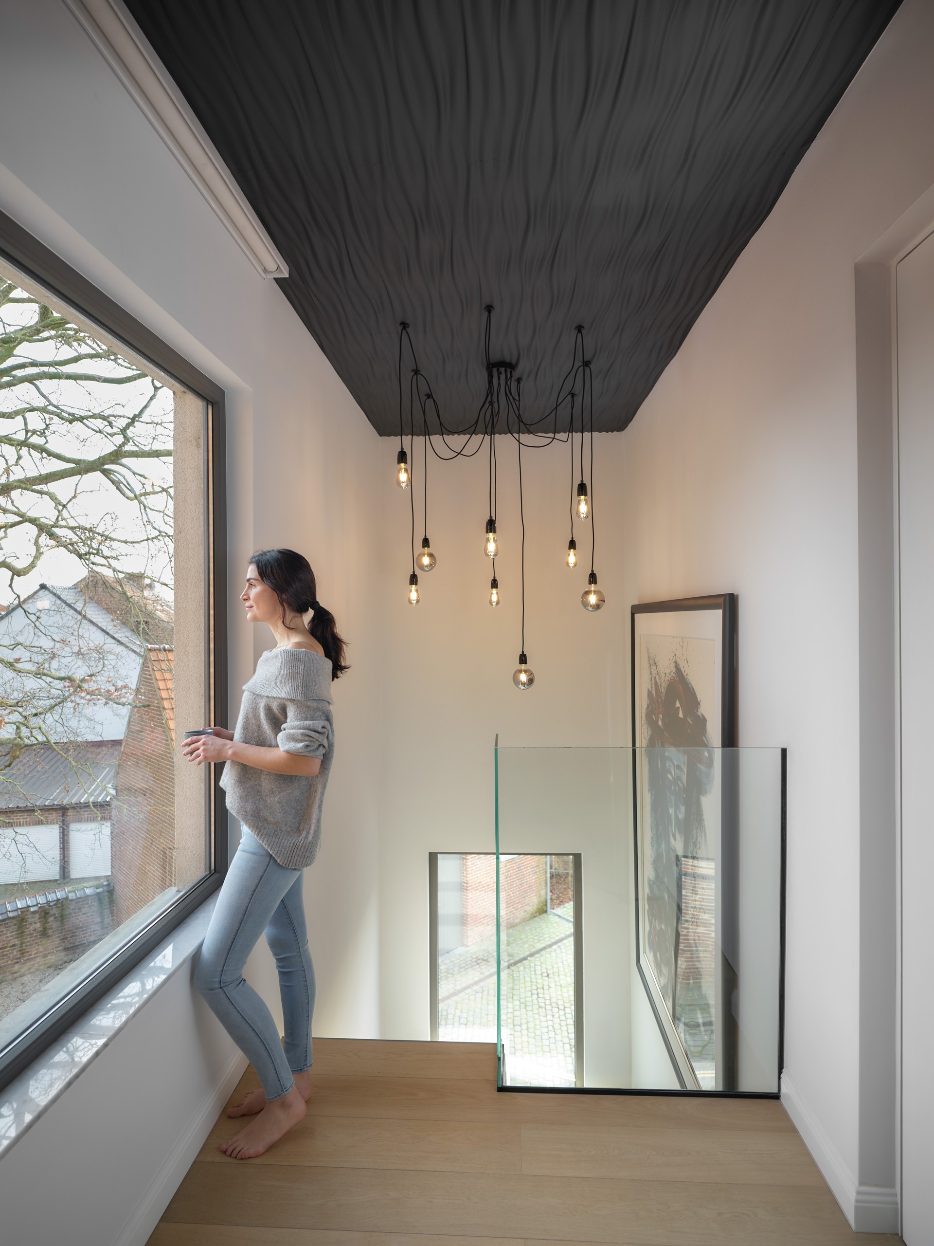 Textured wall panels applied to the ceiling, creating a sculptural ceiling feature with strong visual depth.