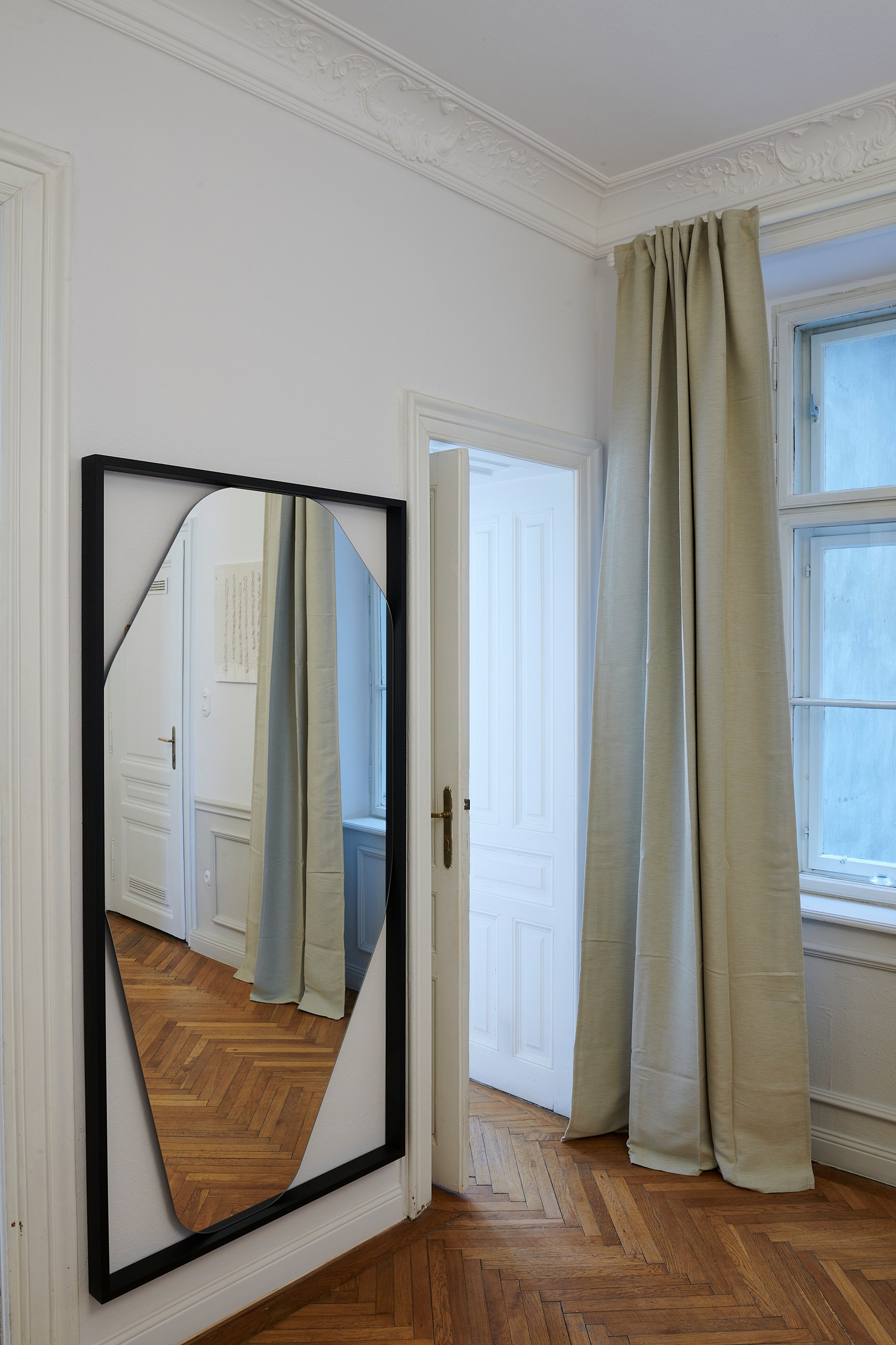Ornate cornices framing the room perimeter and highlighting classic architectural detailing.